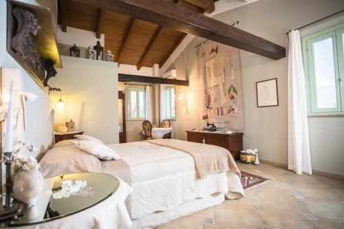 a bedroom with a bed and a table at Locanda Antico Casale Cesenatico in Cesenatico