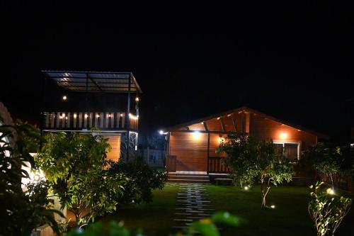 a house at night with lights in the yard at AVY Abode - 3bhk Farm Stay, Private Pool in Moinabad in Venkatāpur