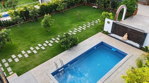 an aerial view of a yard with a swimming pool at AVY Abode - 3bhk Farm Stay, Private Pool in Moinabad in Venkatāpur