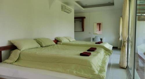 Ένα ή περισσότερα κρεβάτια σε δωμάτιο στο Banrai Pornsawun