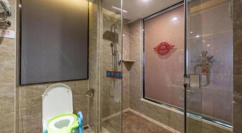 a bathroom with a glass shower with a toilet at Guilin Manhatton Hotel Tianjie in Guilin