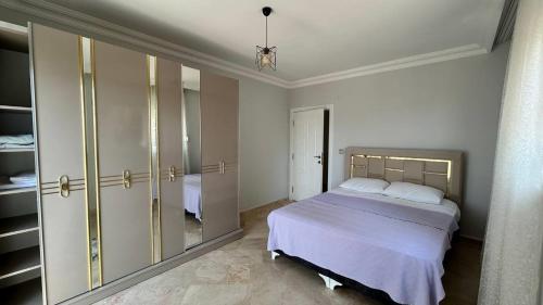 a bedroom with a bed and a large closet at Ambiance Delux Villa with a Private Pool and a View in Alanya