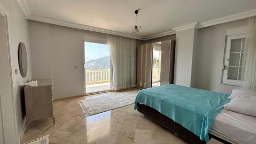 a bedroom with a bed and a large window at Ambiance Delux Villa with a Private Pool and a View in Alanya
