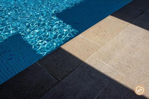 a shadow of a pool of water on the floor at Hotel Les Restanques De Moustiers in Moustiers-Sainte-Marie