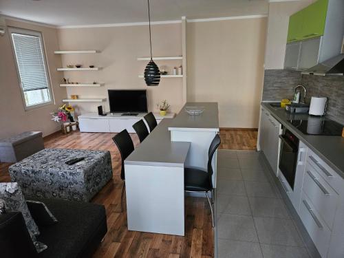 a kitchen and living room with a table and chairs at Hawaii- 2 bdr, Arena, Sava centar, FREE PARKING in Novi Beograd