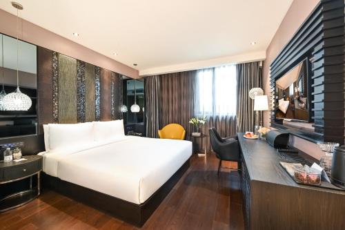 a hotel room with a bed and a desk at Beijing Nanluoguxiang Orange Crystal Hotel in Beijing