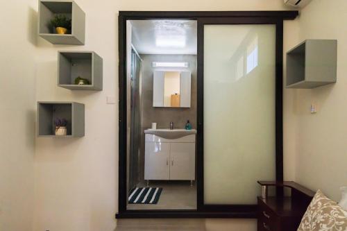 a bathroom with a mirror and a sink at Central Cosy Comfort Suite in Nicosia