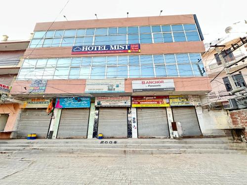 a building with a lot of garage doors at Hotel Mist - Budget AC Rooms Near Chandigarh in Chandīgarh
