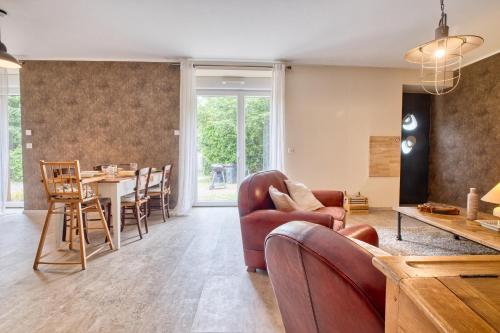 a living room with a couch and a table at La Chanconie in Chez le Turc