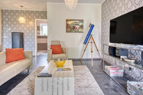 a living room with a couch and a tv at La Chanconie in Chez le Turc