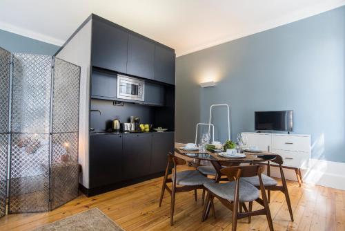 a kitchen and dining room with a table and chairs at bnapartments Carregal in Porto