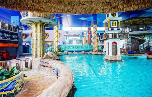 a pool in a mall with a water slide at Beluga Sanya Discovery Ocean World in Shangsimacun