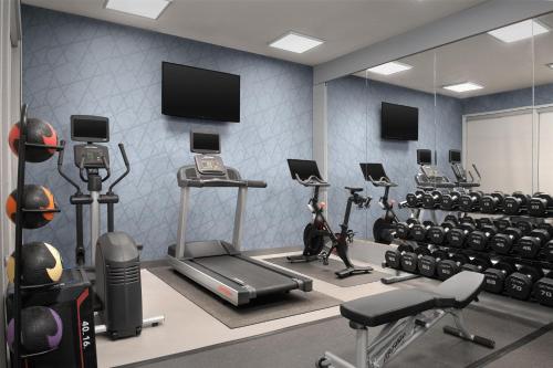 a gym with treadmills and exercise equipment and a tv at Homewood Suites by Hilton Vancouver / Portland in Vancouver