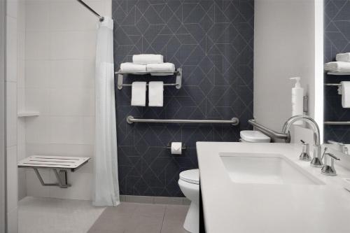 a bathroom with a white sink and a toilet at Homewood Suites by Hilton Vancouver / Portland in Vancouver