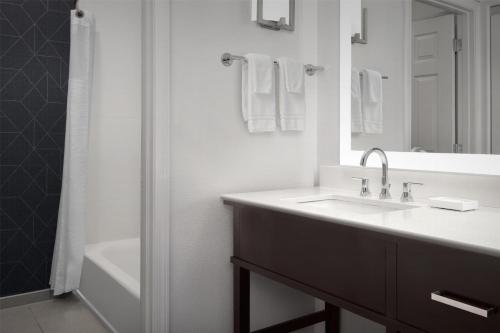a white bathroom with a sink and a shower at Homewood Suites by Hilton Vancouver / Portland in Vancouver