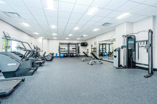 a gym with treadmills and machines in a room at Hilton Garden Inn Charleston Airport in Charleston