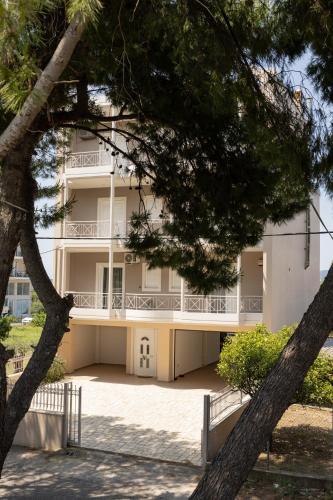 a large white building with trees in front of it at My Nafpaktos Resort in Nafpaktos