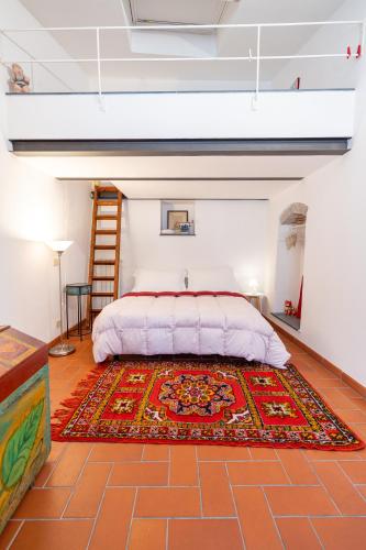 a bedroom with a bed and a rug on the floor at Casa Vacanze Pinuccia in Corniglia