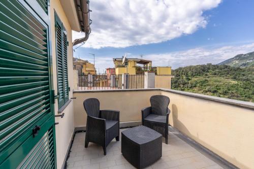 a balcony with chairs and a view of the mountains at Casa Vacanze Pinuccia in Corniglia