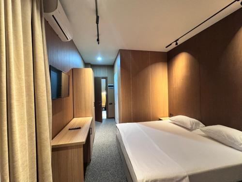 a hotel room with a bed and a television at Nina two in K'obulet'i