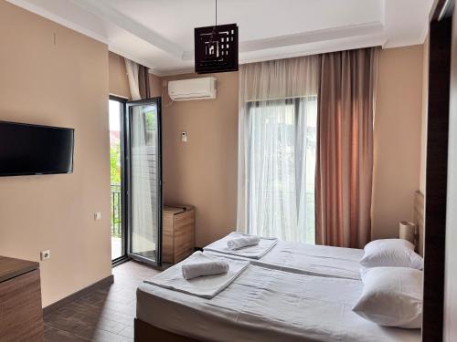 a hotel room with two beds and a television at Nina two in K'obulet'i