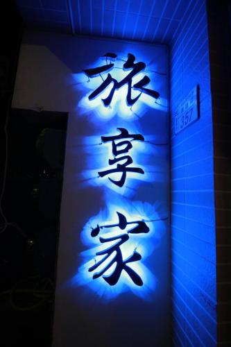 a blue sign with asian writing on a wall at Travel J in Taitung City