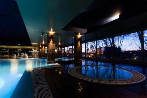 a swimming pool in a building at night at Santana Hotel & SPA in Vila do Conde