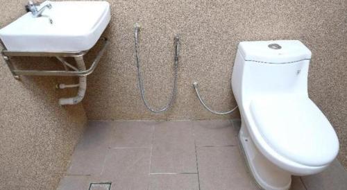 a bathroom with a toilet and a sink at OYO 718 Mr J Hotel Wakaf Che Yeh 1 in Kota Bharu