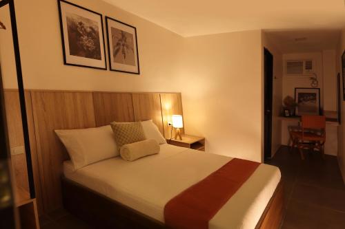 a hotel room with a bed and a chair at Casa Charlie B&B in Manila