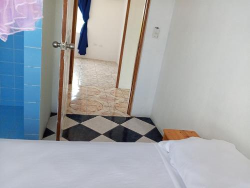a bedroom with a bed and a tiled floor at Christina's Guest House OFFICIAL in Little Corn Island