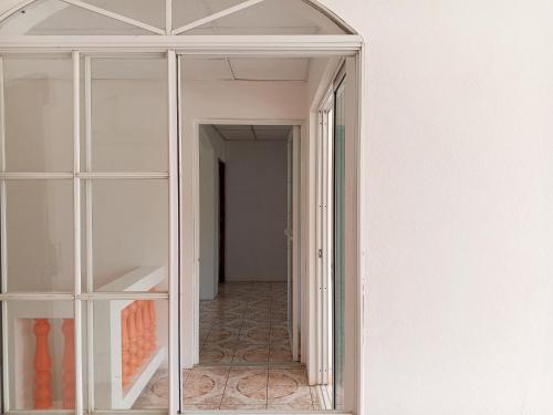 a glass door leading into a room with a hallway at Christina's Guest House OFFICIAL in Little Corn Island