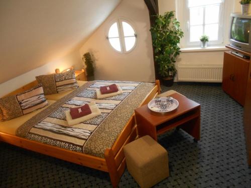 a bedroom with a large bed with a window at Pension a Restaurant VESNA - České Švýcarsko in Srbská Kamenice