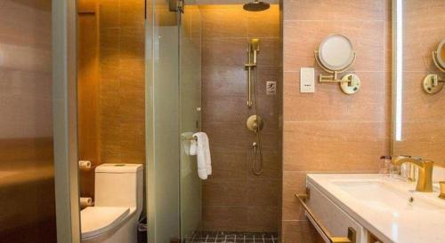 a bathroom with a shower and a toilet and a sink at James Joyce Coffetel· Hefei Anhui Agricultural University in Hefei