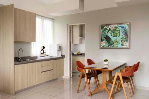 a kitchen and dining room with a table and chairs at TUI BLUE The Haven Ipoh in Ipoh
