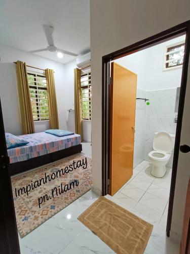 a bathroom with a bed and a toilet in a room at Impian homestay, wcy in Kota Bharu
