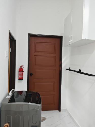 a door to a room with a microwave and a door at Impian homestay, wcy in Kota Bharu