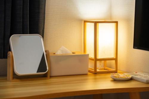 a mirror sitting on top of a wooden table at KAYO NIJO Hotel in Kyoto