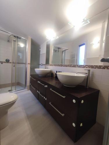 a bathroom with two sinks and a shower at La mansarda del Panfilo in Cervia