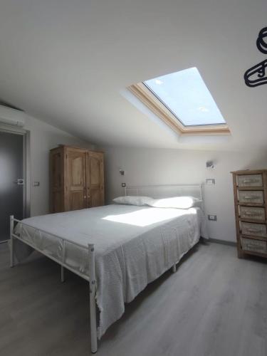 a bedroom with a large bed with a skylight at La mansarda del Panfilo in Cervia