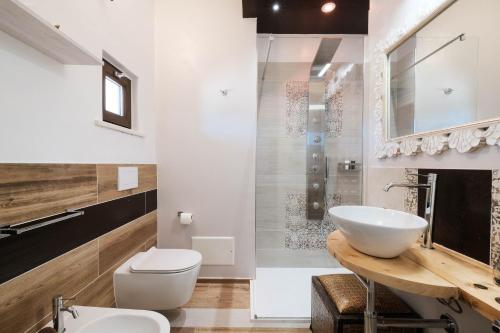 a bathroom with a sink and a toilet at RADICI DI LUNA Exclusive Design in Castelsardo
