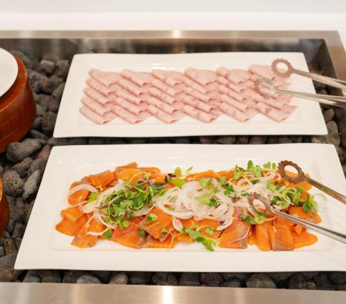 two white plates of food on a table at Hallim Resort in Jeju