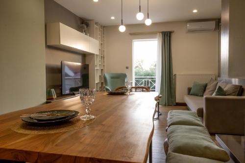 a living room with a table and a couch at My Nafpaktos Resort in Nafpaktos