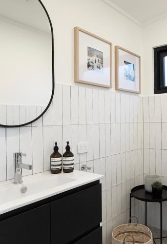 a bathroom with a sink and a mirror at PISTE LUXURY CHALET - THE PETITE - Oaks Lake Crackenback Resort in Crackenback