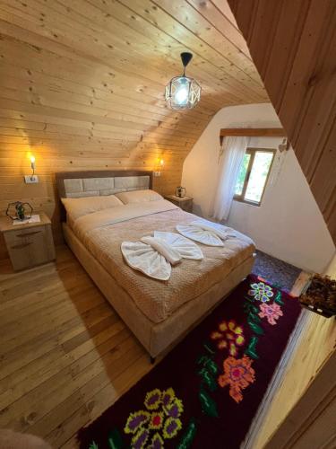 a bedroom with a bed in a wooden cabin at Villa Belinis in Theth