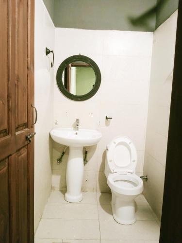 a bathroom with a sink and a toilet and a mirror at Bela Resorts Naran in Nārān