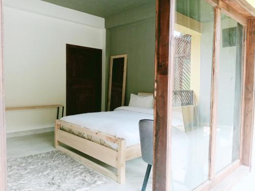 a bedroom with a bed and a window at Bela Resorts Naran in Nārān