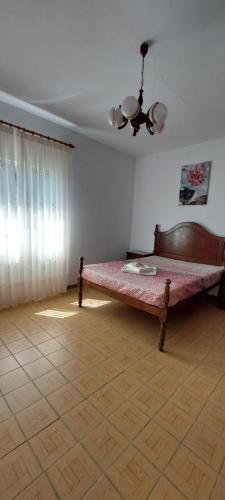 a bedroom with a bed in the corner of a room at Casa do Vale in Arcos de Valdevez