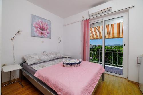 a bedroom with a bed with a basket on a table at Apartments and rooms Bionda in Senj