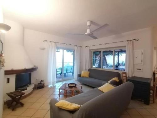 a living room with a couch and a table at Costa dei Monaci Villas - Tropea in Parghelia