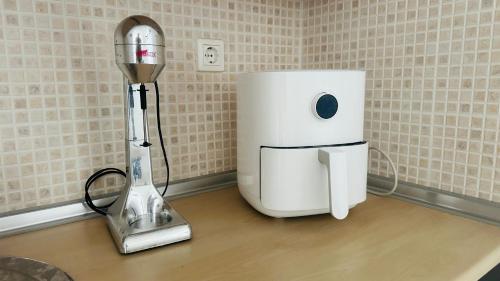 a kitchen counter with a blender and a appliance on it at Sky studio in Nea Kalikratia